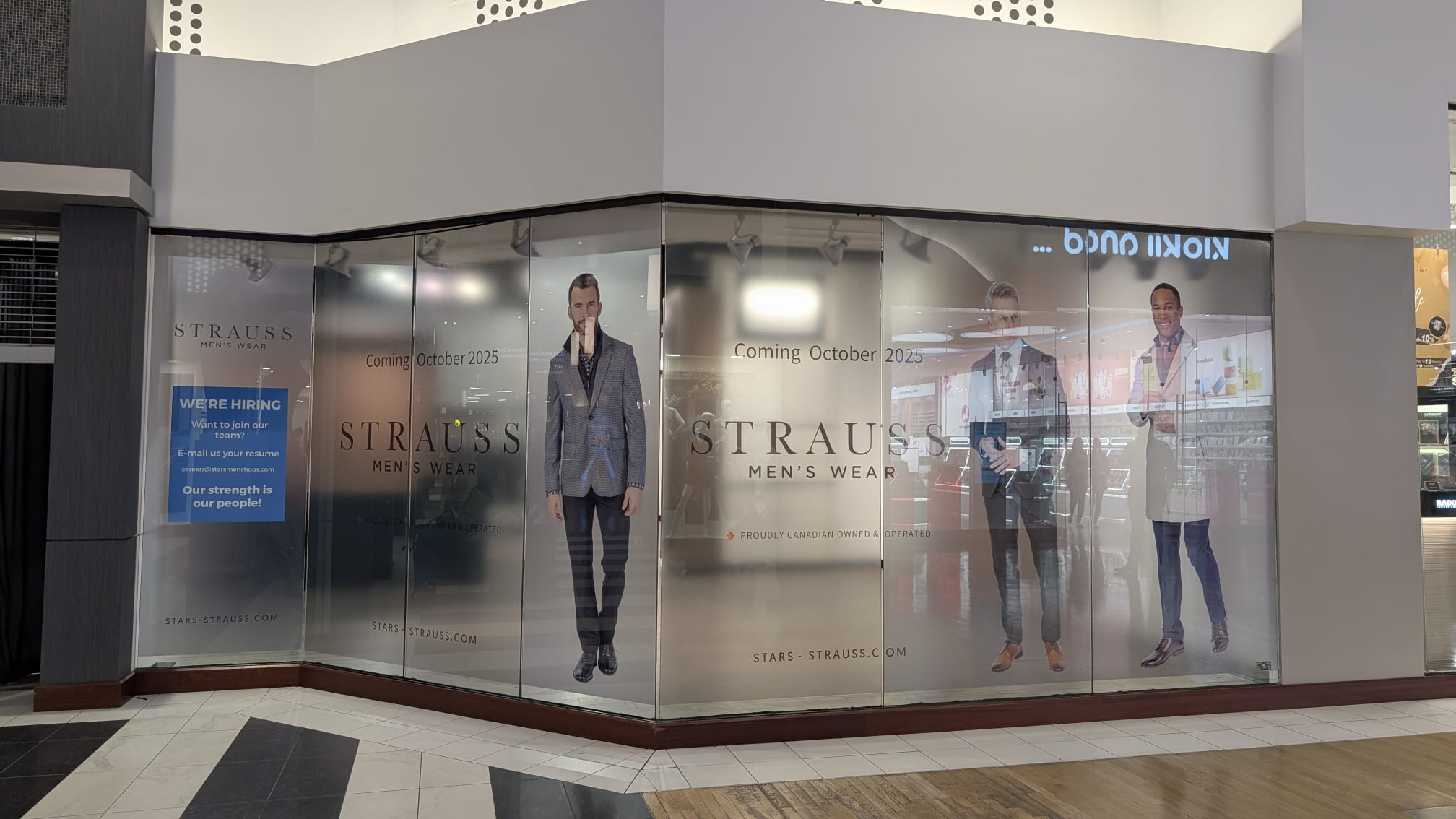 Frosted window graphics wrapping a mall storefront