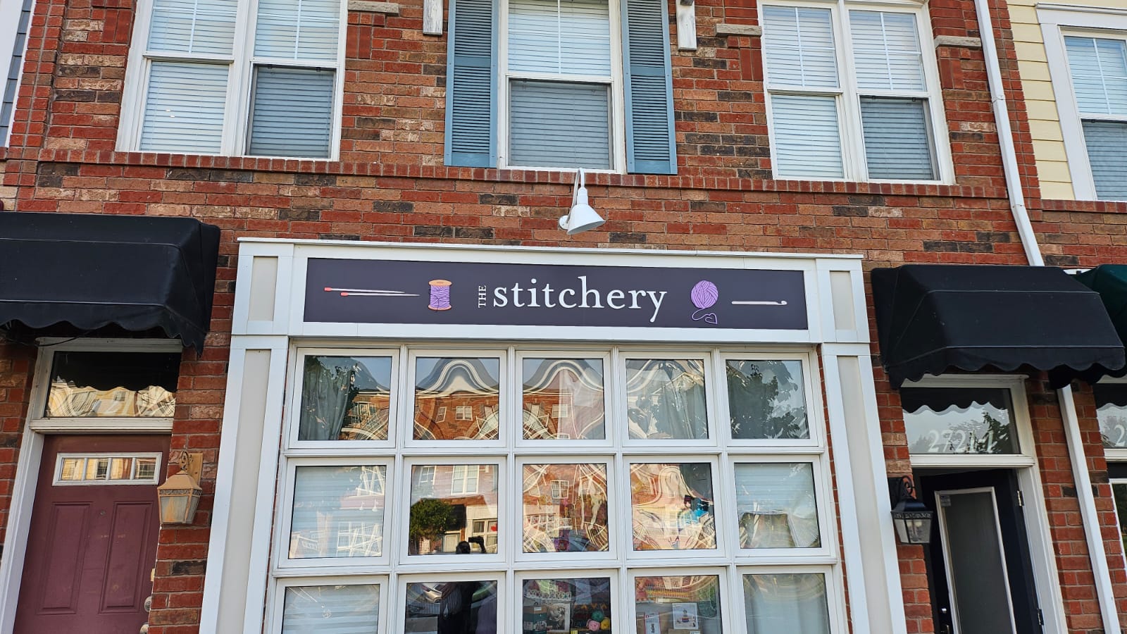 Storefront fascia sign on a brick building